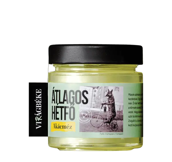 Virágbéke "Átlagos hétfő" akácméze látható, a méz színe szép, aranyszínű sárga. A kupak fekete. 