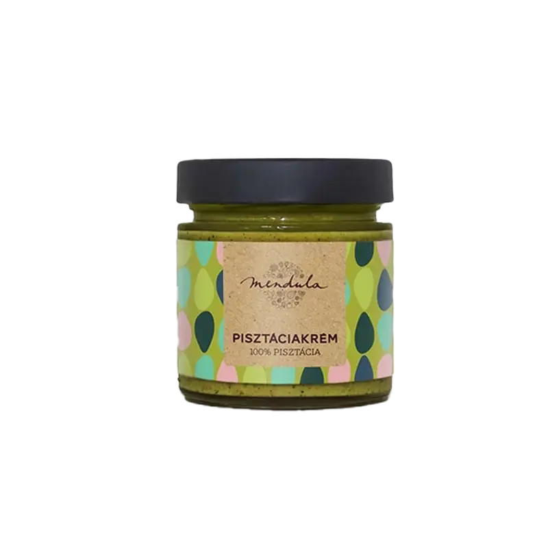 Mendula 100% pisztáciakrém, az üvegben látszik a szépen elkészített zöldszínű pisztáciakrém. A címkén zöld, világoszöld, sötétszöld és rózsaszín pötyök láthatóak, a címke alapszíne a világos zöld. A kupak színe fekete. 