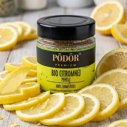 Pödör prémium bio citromhéj látható a képen, amely 100%-ban természese eredtű. A címke színe citromsárga és fekete, a Pödör prémium felirat aranyszínű. Az üveg körül szeletelt citromhéjak találhatóak. 